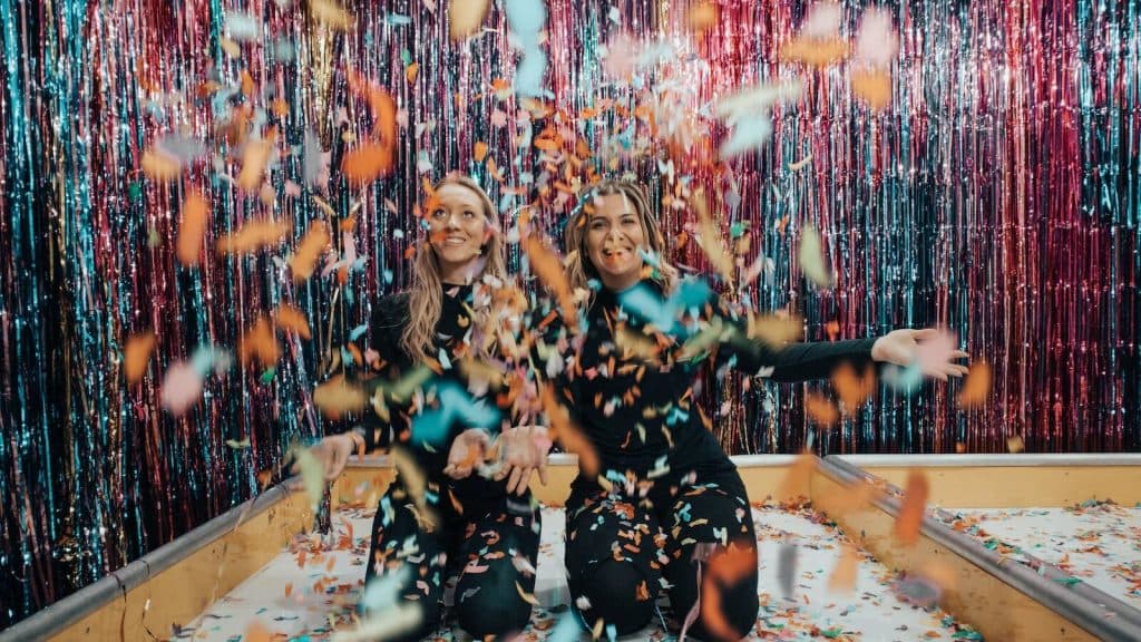 two women enjoying confetti