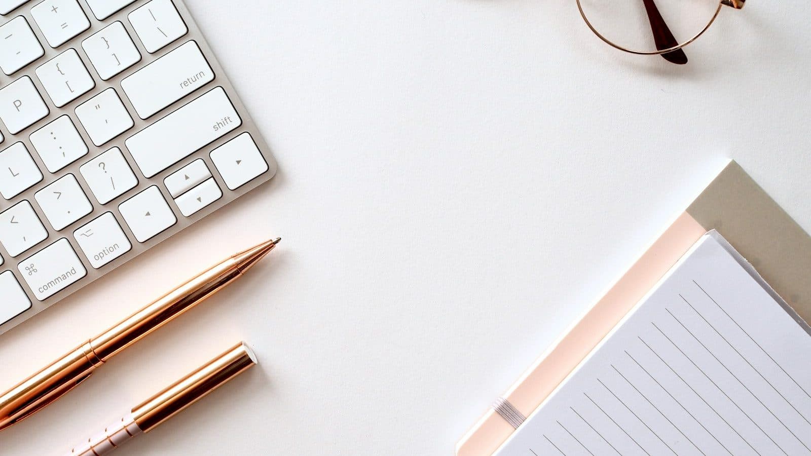 pen near black lined paper and eyeglasses