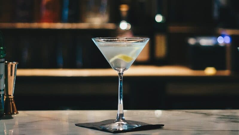 clear martini glass on brown wooden table