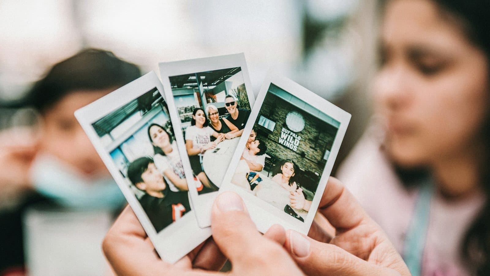 person holding 2 women photo